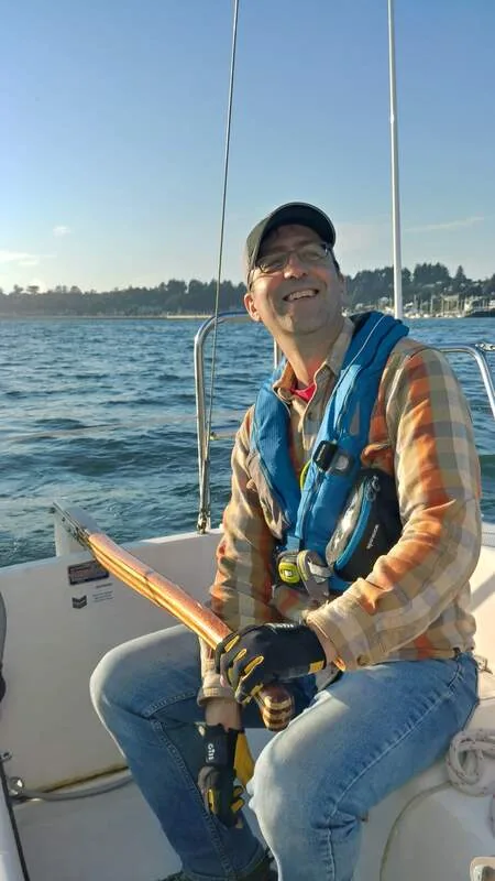 A Capri Club skipper smiling while sailing Fulmar